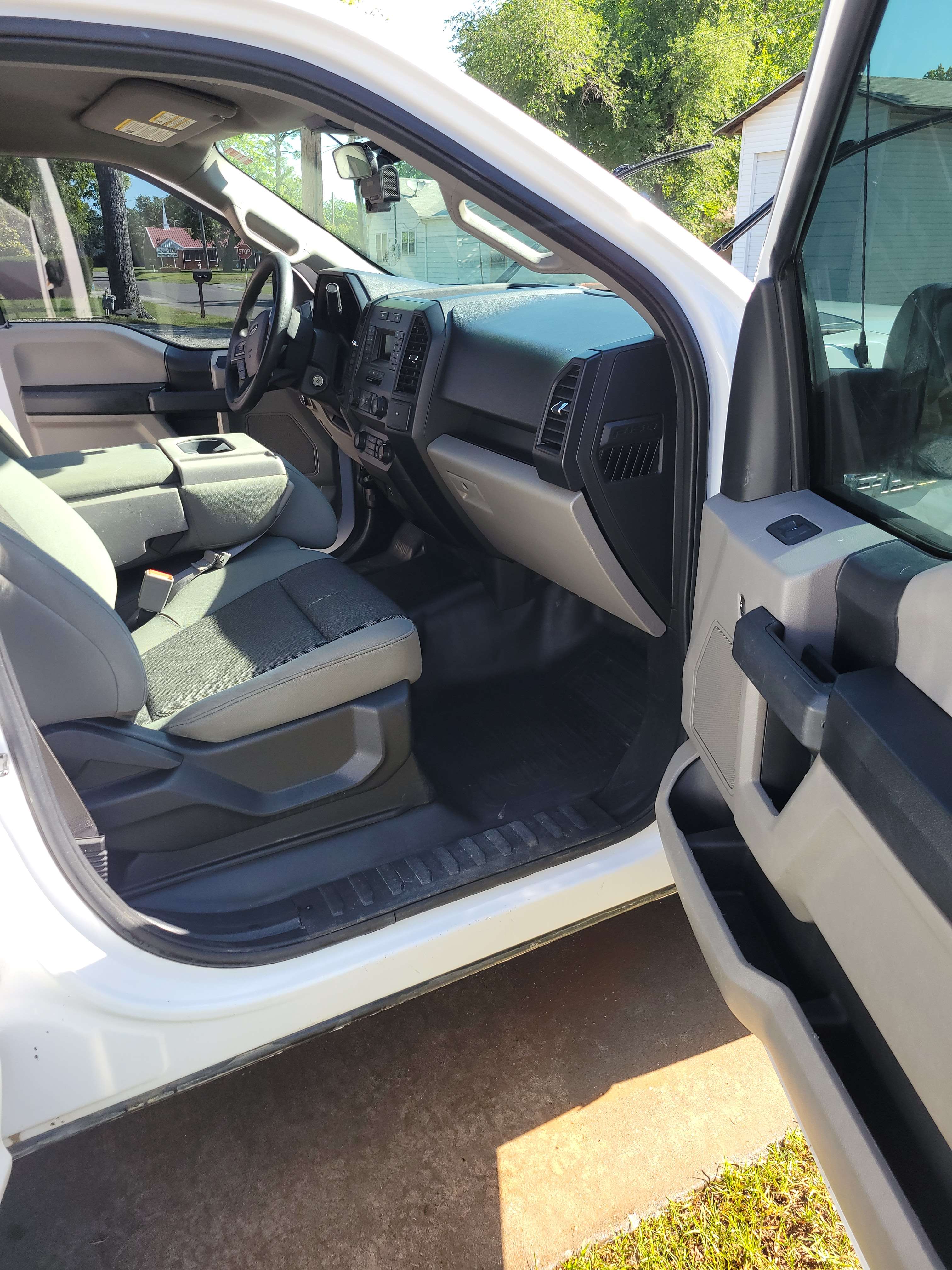 Clean front interior of a Ford F-150 work truck.