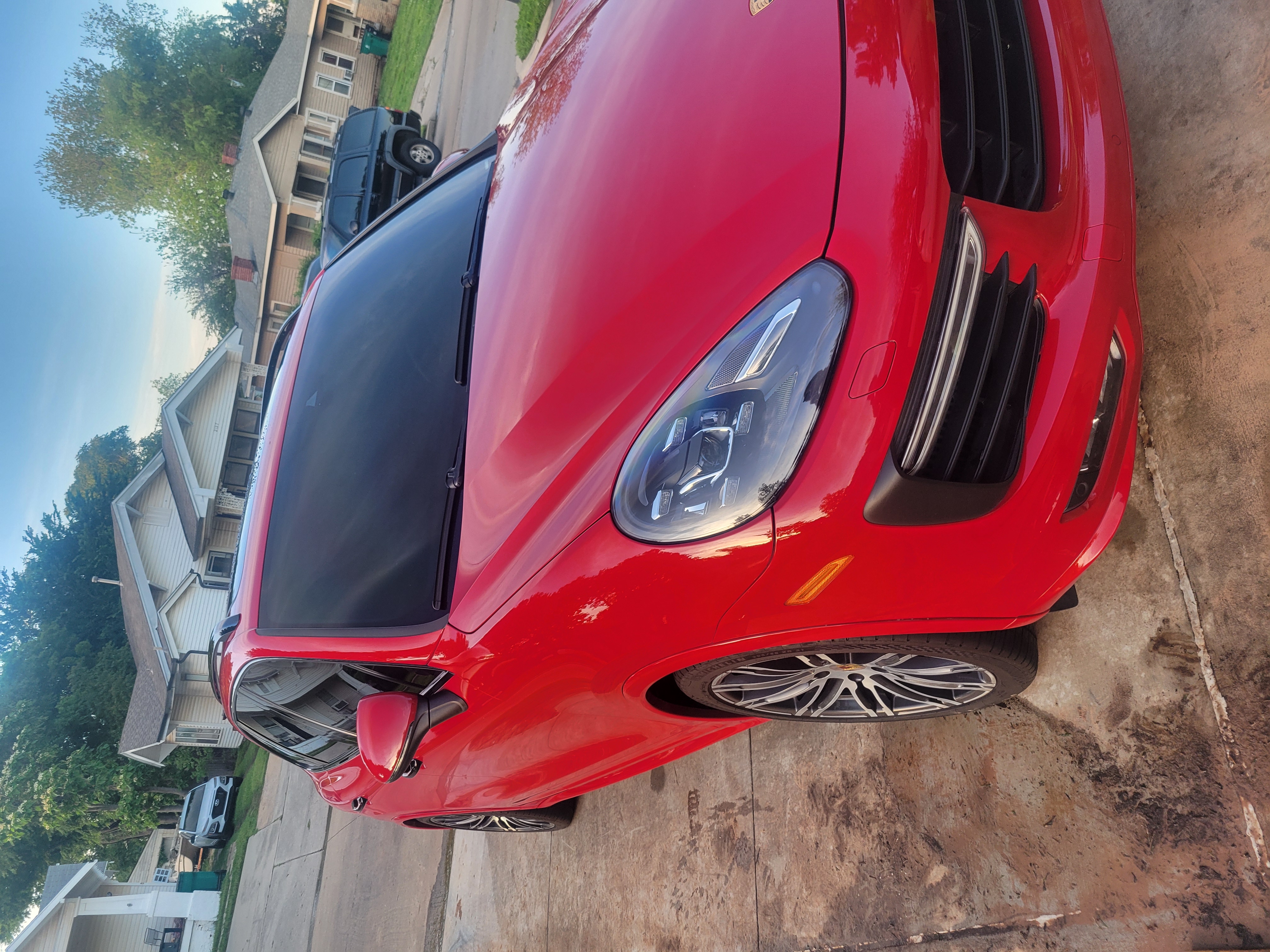 Vibrant red Porsche Cayenne with a deep gloss.